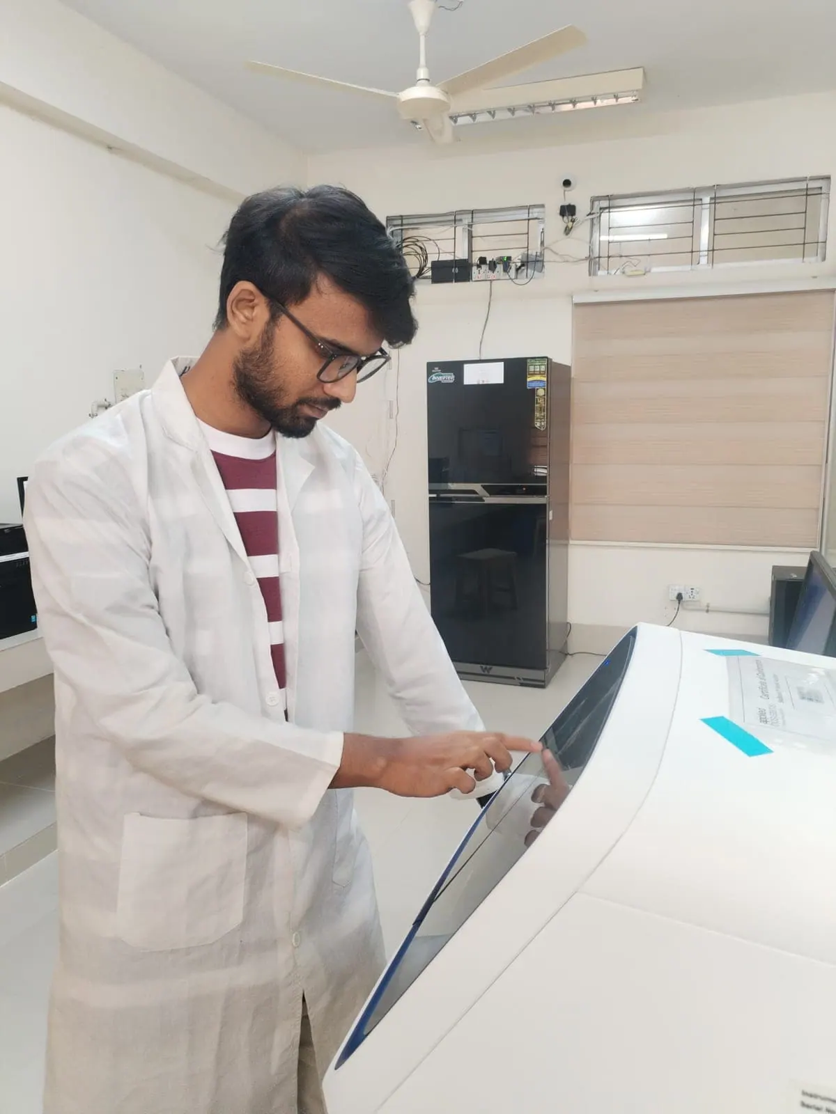 Loading a PCR plate into the thermal cycler at the Functional Genomics & Proteomics Laboratory.